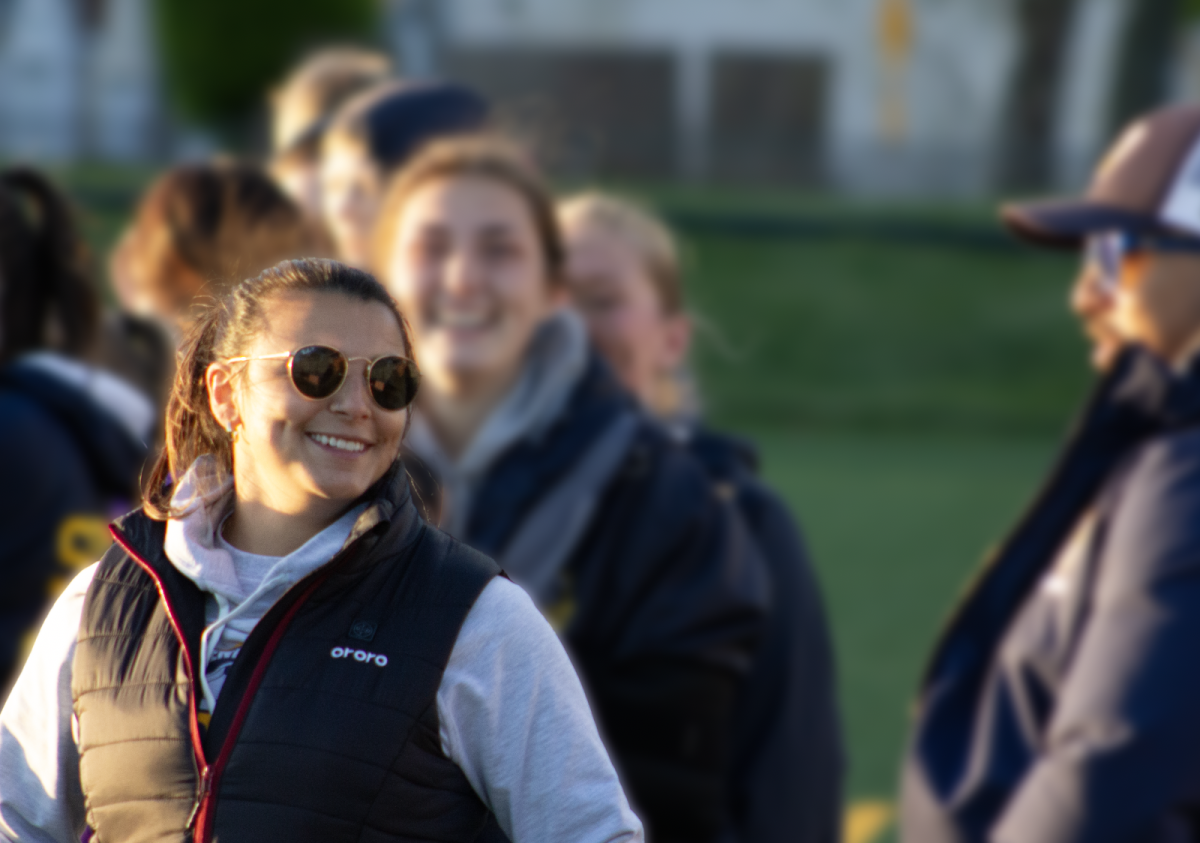 TEAMWORK MAKES THE DREAM WORK: Girls’ Varsity Soccer Head Coach Cassidy Price coaches and cheers on her athletes during the Girls’ Varsity Conference match. The game took place on May 8 against Evanston Township High School. 